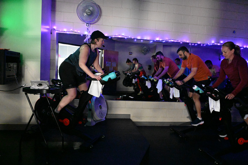 Cycle and spin class in session at Bethany Athletic Club in Portland, Oregon, with members riding stationary bikes
